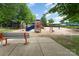 This community playground features a variety of play structures and a seating area with a bench at 6726 Carradale Way, Charlotte, NC 28278