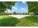 A beautifully maintained community volleyball court is surrounded by lush green grass and mature trees at 6726 Carradale Way, Charlotte, NC 28278