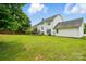 Large, grassy backyard with mature trees and charming deck creates a serene outdoor oasis at 6821 Millingden Ct, Charlotte, NC 28277