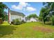 Well-maintained backyard featuring a lush lawn, deck, and white-sided home at 6821 Millingden Ct, Charlotte, NC 28277