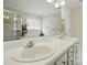 Bright bathroom featuring double sinks, a soaking tub, and a glass-enclosed shower at 6821 Millingden Ct, Charlotte, NC 28277