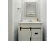 Stylish half bath with white vanity featuring trendy sliding doors and modern mirror at 6821 Millingden Ct, Charlotte, NC 28277
