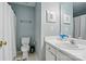 Functional bathroom with a toilet, shower with a curtain, and a sink with storage space at 6821 Millingden Ct, Charlotte, NC 28277