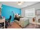 A vibrant bedroom with a light green bed frame, a fan, and a bright turquoise wall at 6821 Millingden Ct, Charlotte, NC 28277
