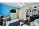 Spacious bedroom featuring bright blue wall, fan, closet, and a comfortable bed at 6821 Millingden Ct, Charlotte, NC 28277