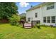 Landscaped backyard with wooden deck for relaxing and entertaining at 6821 Millingden Ct, Charlotte, NC 28277