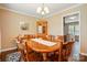 Traditional dining room with a wooden table and chairs, complemented by a corner china cabinet at 6821 Millingden Ct, Charlotte, NC 28277