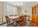 Bright dining room features wood table set, rug and built-in china cabinet and natural light at 6821 Millingden Ct, Charlotte, NC 28277