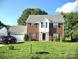 Charming brick two-story home with a well-manicured lawn and attached two-car garage at 6821 Millingden Ct, Charlotte, NC 28277