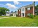 Charming brick two-story home with a well-manicured lawn and an attached two-car garage at 6821 Millingden Ct, Charlotte, NC 28277