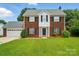 Charming brick two-story home with a well-manicured lawn and attached two-car garage at 6821 Millingden Ct, Charlotte, NC 28277