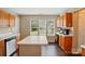 This kitchen features an island, a window with natural light, wooden cabinets, and modern appliances at 6821 Millingden Ct, Charlotte, NC 28277