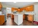 A cozy kitchen featuring wooden cabinets, an island, stainless steel appliances, and tile flooring at 6821 Millingden Ct, Charlotte, NC 28277