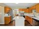 Bright kitchen with wooden cabinets, white countertops, stainless steel appliances and tile floors at 6821 Millingden Ct, Charlotte, NC 28277