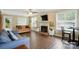 Spacious living room with a brick fireplace, hardwood floors, and ample natural light at 6821 Millingden Ct, Charlotte, NC 28277