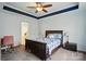 Comfortable bedroom with fan and ensuite bathroom entrance at 6821 Millingden Ct, Charlotte, NC 28277