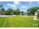 Lovely shot of neighborhood street showing mature trees and well-kept lawns at 6821 Millingden Ct, Charlotte, NC 28277