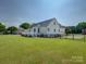 Expansive backyard featuring a well-maintained lawn and a charming white deck, perfect for outdoor gatherings at 736 Creekbridge Dr, Rock Hill, SC 29732