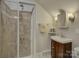 Cozy bathroom featuring glass-enclosed shower with unique tile, dark vanity with white sink at 736 Creekbridge Dr, Rock Hill, SC 29732
