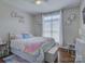 Cozy bedroom featuring a large window, hardwood flooring, and a comfortable bed at 736 Creekbridge Dr, Rock Hill, SC 29732