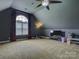 Large carpeted bonus room with a window, fan, and entertainment center at 736 Creekbridge Dr, Rock Hill, SC 29732