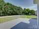 Expansive gray wood deck overlooking a well-kept lawn and a playground, perfect for outdoor living at 736 Creekbridge Dr, Rock Hill, SC 29732
