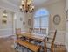 Elegant dining room featuring a large window, chandelier, and hardwood floors at 736 Creekbridge Dr, Rock Hill, SC 29732