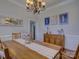 Dining room featuring hardwood floors, wainscoting, updated lighting, and neutral paint at 736 Creekbridge Dr, Rock Hill, SC 29732