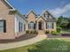 Well-maintained brick home with black shutters, tidy landscaping, and a walkway to the front door at 736 Creekbridge Dr, Rock Hill, SC 29732