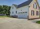 Exterior shot of the attached two-car garage with brick and white siding, ample parking at 736 Creekbridge Dr, Rock Hill, SC 29732