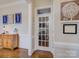 Hallway with hardwood floors, neutral paint, white trim, and a glass-paneled door at 736 Creekbridge Dr, Rock Hill, SC 29732