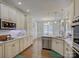 Well-lit kitchen with a breakfast nook, marble countertops, stainless steel appliances, and abundant cabinet space at 736 Creekbridge Dr, Rock Hill, SC 29732