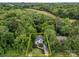 Aerial view of a charming home nestled amongst mature trees on a private lot at 7830 Sarah Dr, Denver, NC 28037