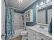 Well-maintained bathroom featuring a shower-tub combo, vanity, and decorative fixtures at 7830 Sarah Dr, Denver, NC 28037