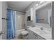 Bathroom features a shower-tub combo with a blue shower curtain and a vanity with sink at 7830 Sarah Dr, Denver, NC 28037
