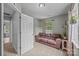 Cozy bedroom with a comfortable brown sofa, and a window with natural light at 7830 Sarah Dr, Denver, NC 28037