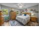 Comfortable bedroom with natural light, wooden furniture, and cozy rug at 7830 Sarah Dr, Denver, NC 28037