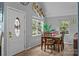 Bright dining room with hardwood floors, plenty of sunlight, and stylish decor at 7830 Sarah Dr, Denver, NC 28037