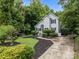 Charming home with a concrete driveway, a lush lawn, and manicured landscaping at 7830 Sarah Dr, Denver, NC 28037