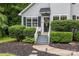 Close up of the front of a home featuring a welcoming doorway and lush landscaping at 7830 Sarah Dr, Denver, NC 28037