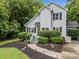 Charming home featuring a manicured front yard with a lighted pathway leading to the front door at 7830 Sarah Dr, Denver, NC 28037