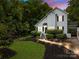 Charming two-story home with a well-manicured front yard, a lighted pathway, and lush landscaping at 7830 Sarah Dr, Denver, NC 28037