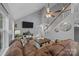 Spacious living room with a sectional couch, tall ceilings, and natural light at 7830 Sarah Dr, Denver, NC 28037