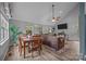 Open-concept living room with hardwood floors, a comfortable sectional couch, and natural light at 7830 Sarah Dr, Denver, NC 28037