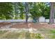 Serene backyard featuring a fire pit, playground, storage shed, and white fence creating a private outdoor retreat at 8020 Sheckler Ln, Matthews, NC 28104