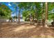 Expansive backyard featuring a playground, fire pit area, and deck, offering ample space for recreation at 8020 Sheckler Ln, Matthews, NC 28104