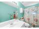 Bathroom features a white sink, a toilet, and a beach themed shower curtain at 8020 Sheckler Ln, Matthews, NC 28104