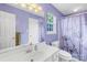 This bathroom features a white sink and vanity with an ornate lighting fixture at 8020 Sheckler Ln, Matthews, NC 28104