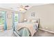 Cozy bedroom with vaulted ceiling, ceiling fan, and large windows for natural light at 8020 Sheckler Ln, Matthews, NC 28104