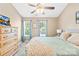 Comfortable bedroom with a ceiling fan, dresser, and soothing, neutral color scheme at 8020 Sheckler Ln, Matthews, NC 28104